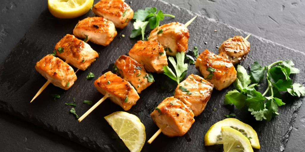 Salmon and chicken summer skewers on golden rice